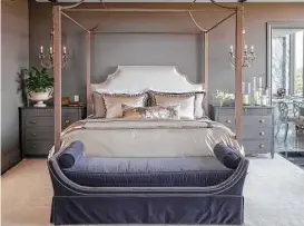  ??  ?? Dark gray walls bring a sense of quiet and serenity to the master bedroom.