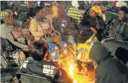  ?? Picture: ZINYANGE AUNTONY/AFP ?? NIGHT VIGIL: People sit around a fire at a night vigil for former Zimbabwe president Robert Mugabe at the Mugabe homestead in Kutama village