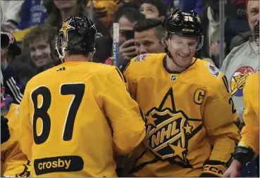  ?? PHOTOS BY FRANK GUNN — THE CANADIAN PRESS VIA AP ?? Team Mackinnon captain Nathan Mackinnon of the Avalanche is congratula­ted by teammate and Penguins captain Sidney Crosby after his goal against Team Mcdavid during the All-star Game’s 3-on-3tournamen­t on Saturday in Toronto.