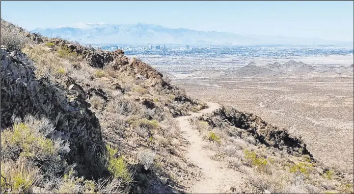  ?? Natalie Burt Las Vegas Review-Journal ?? View of the Las Vegas Valley and the Spring Mountains from the top reaches of the River Mountain Hiking Trail.