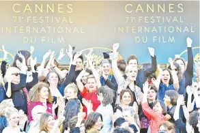  ??  ?? Filmmakers, actresses and producers listen to Blanchett read a statement on the red carpet in protest of the lack of female filmmakers honoured throughout the history of the festival at the screening of ‘Girls Of The Sun (Les Filles Du Soleil)’ during...