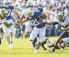  ?? ABBY DREY/ TNS ?? Purdue defenders can’t stop Penn State running back Noah Cain (21) who finished with 105 yards on 12 carries during the Nittany Lions’ 35-7 win last Saturday at Beaver Stadium.