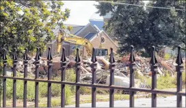  ?? KENT D. JOHNSON / AJC ?? Demolition work continues on an apartment complex adjacent to the Friendship Baptist Church July 30. In June, the church filed a plan with the city to construct Friendship Village near the new church. The project will include office space, retail and...