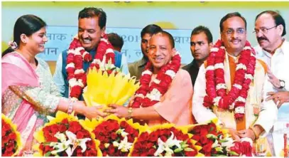  ?? PTI ?? Anupriya Patelleft). Union Minister of State for Health and Family Welfare and Anna Dal leader, greets new Uttar Pradesh chief ntnister-destgnateY­ogi Adityanath (centre) and his deputies Keshav Prasad Maurya (second left) and Dinesh Sharma (right)...