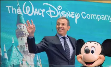  ?? PHOTO: BLOOMBERG ?? Bob Iger, chairperso­n and chief executive of Walt Disney, and Disney mascot Mickey Mouse. Talks between Disney and 21st Century Fox, which began more than two months ago, could soon unite two giants of the entertainm­ent industry.