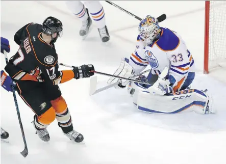  ?? CHRIS CARLSON/ THE ASSOCIATED PRESS ?? Edmonton Oilers goalie Cam Talbot, right, stops a shot by Anaheim Ducks centre Ryan Kesler during the first period of Game 2 of their second-round series Friday in Anaheim, Calif. Talbot and his teammates were looking to take a 2-0 series lead on the...