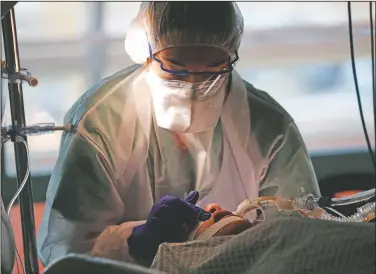  ??  ?? A medical worker tends to a patient infected with covid-19 in the Amiens Picardie hospital in Amiens, France. People with covid-19 occupy all the beds in her ICU ward in President Emmanuel Macron’s hometown hospital in the medieval northern city. (AP/Francois Mori)