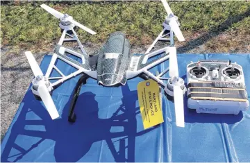  ?? [AP PHOTO] ?? Above: This Aug. 24 file photo shows a Yuneec Typhoon drone and controller in Jessup, Md. Maryland State Police and prison officials say two men planned to use the drone to smuggle drugs, tobacco and pornograph­y videos into the maximum-security Western...