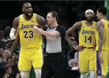  ??  ?? Los Angeles Lakers forward LeBron James (23) argues a call with the referee as Lakers forwards Brandon Ingram (14) and Kyle Kuzma (0) talk to each other in the fourth quarter of an NBA basketball game against the Boston Celtics, on Thursday, in Boston. AP PHOTO/ELISE AMENDOLA