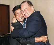  ??  ?? Bitterswee­t meeting: Ham (right) hugging Dong Chan at the Diamond Mountain resort in North Korea. — AP