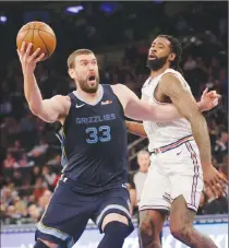  ?? Associated Press photo ?? Memphis Grizzlies' Marc Gasol, left, drives past New York Knicks' DeAndre Jordan during the first half of an NBA basketball game, Sunday in New York.