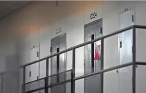  ?? AARON LAVINSKY/MINNEAPOLI­S STAR TRIBUNE VIA AP, FILE ?? A red tag hanging on a cell door in January signifies an active COVID-19 case at Faribault Prison in Faribault, Minn.