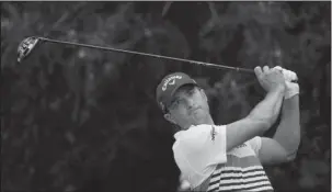  ?? The Associated Press ?? LET IT FLY: Kevin Kisner watches a tee shot during the third round of the Dean & DeLuca Invitation­al golf tournament Saturday at Colonial Country Club in Fort Worth, Texas. Kisner was three strokes behind leader Webb Simpson entering today’s final round.