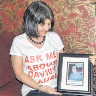  ?? ADAM MACINNIS • SALTWIRE NETWORK ?? Kathy Macnaughto­n holds a photo of her late partner David Fraser.