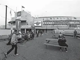  ?? JED JACOBSOHN/AP ?? Fans walk into the Oakland Coliseum before a game against the Orioles on Monday in Oakland, Calif.