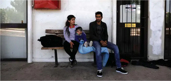  ?? (Reuters) ?? A REFUGEE family from Afrin waits at a train station in the city of Orestiada, Greece.