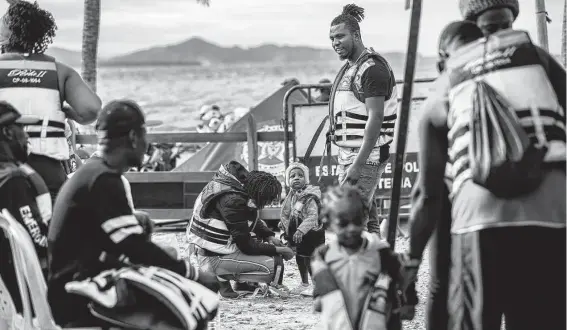  ?? ?? A child gets zipped up in a life preserver before boarding a boat from Necoclí to Acandí in Colombia as migrants start their journey to the Darién Gap on Nov. 4.