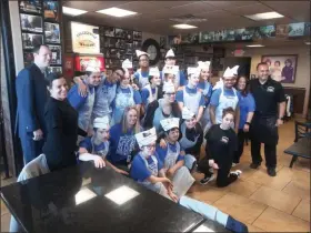  ?? GARY PULEO - MEDIANEWS GROUP ?? Best Buddies participan­ts and bakery staff posing for a group photo are flanked by Collegevil­le Bakery owners Patrizia Carcarey, far left, and Steve Carcarey, far right.