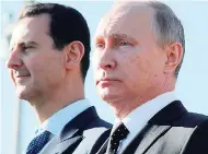  ?? FILE ?? This Monday, December 11, 2017 file photo, Russian President Vladimir Putin (right) and Syrian President Bashar Assad watch the troops marching at the Hemeimeem airbase in Syria.