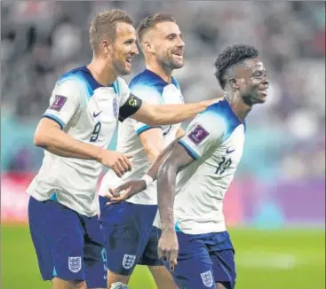  ?? AP ?? England's Bukayo Saka (R) celebrates after scoring his side's fourth goal against Iran during their World Cup match on Monday.