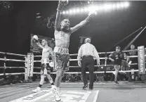  ?? Mikey Williams / Top Rank via Getty Images ?? San Antonio’s Josh Franco, right, celebrates his one-sided victory over Andrew Moloney for the WBA’S regular super flyweight title on Aug. 14 in Catoosa, Okla.