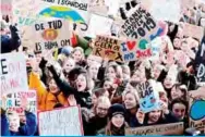  ?? —AFP ?? LEUVEN: Youths hold placards and shout slogans during a ‘Youth For Climate’ rally in Leuven, calling on authoritie­s to take action on climate and ecological issues.