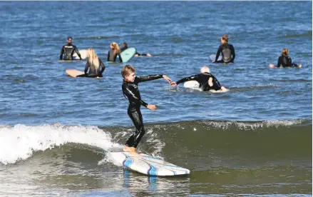  ?? KARL MONDON/STAFF ?? Oliver Ebinger, 8, of Daly City, catches a wave Monday morning at Pacifica State Beach. Sunday was the hottest day of the year across the Bay Area, but the weather is expected to be slightly cooler starting today.