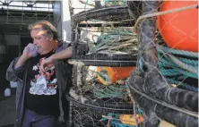  ?? Michael Macor / The Chronicle 2015 ?? Crabber and fishing associatio­n chief Larry Collins stands near his crab pots in November, when boats were idled.