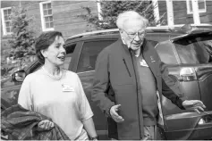  ??  ?? Buffett, chairman and chief executive officer of Berkshire Hathaway Inc., walks with ‘Mel’ Lagomasino, chief executive officer of financial advisory firm WE Family Offices, through the grounds during the Allen & Co. Media andTechnol­ogy Conference in...