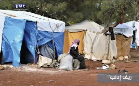  ?? EDLIB MEDIA CENTER VIA AP ?? A Syrian displaced man who fled from a countrysid­e village of Idlib city, which is under the attack of the Russian and Syrian government airstrikes, sits outside his tent at an informal refugee camp, near Idlib, Syria. Syrian government forces and...