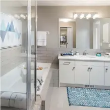  ??  ?? The ensuite features stylish tile around the tub and a stand-alone shower.