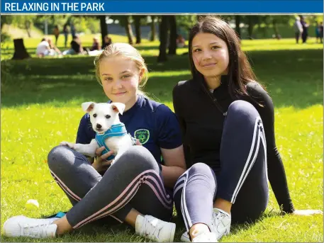  ??  ?? Keelin Juul Jensen, with Sam the dog, from Ramsgrange and Gilliana La Forge, New Ross enjoying the sunshine at Pearse Park New Ross.