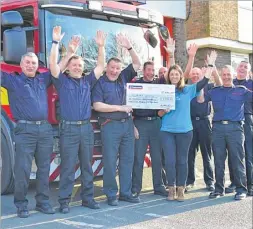  ?? ?? Canterbury fire station’s red watch hand over the cheque to Pilgrims Hospice representa­tives