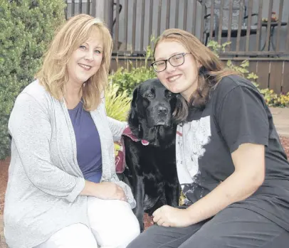  ?? LYNN CURWIN/TRURO NEWS ?? Carla, left, and Ama Carey have discovered several benefits to having Bevin, a Labrador retriever, in their home. Bevin is a Dog Guide trained in autism assistance.