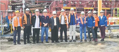  ??  ?? (From third left) Gerard, Hashim, Hassan, Lau, Yang and others in a group photo in front of the vessel MT Team Houston that will export the CPO to India.