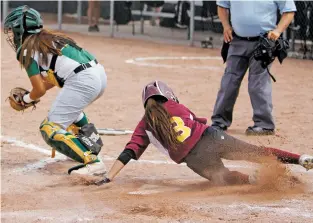  ?? LUIS SÁNCHEZ SATURNO/THE NEW MEXICAN ?? Santa Fe Indian High School’s Franki Chavez slides safely home past West Las Vegas’ catcher Elena Archuleta during the bottom of the third inning of a Wednesday game in the Class 4A State Softball Tournament at Cleveland High School.