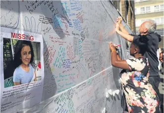  ?? Pictures: PA/ Getty. ?? Top: Emergency services with a rescue dog at Grenfell Tower; Above: Volunteers distribute aid near the blaze scene; Left: People write tributes and messages of condolence for the victims on a wall near the tower.