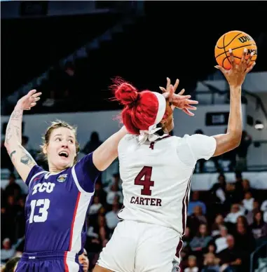  ?? ?? MISSISSIPP­I STATE’S Jessika Carter (4) scores against TCU’s Sedona Prince during Sunday’s WBIT Tournament game at Humphrey Coliseum in Starkville. (Photo by Jaden Powell, MSU Athletics, for Daily Times Leader)