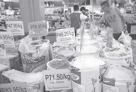  ?? ?? THIS Businessmi­rror file photo shows an assortment of commercial rice on sale at a grocery store in Antipolo City.