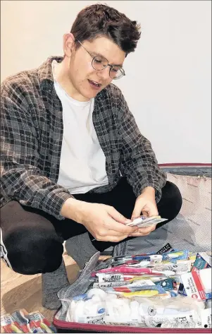  ?? SUBMITTED PHOTO ?? Jake Shea of Anglo-Tignish sorts through a supply of medical, dental and hygiene products he and fellow members of the Dalhousie chapter of Global Brigades will be distributi­ng in Honduras this week. This is Shea’s second visit to the country with...