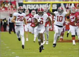  ?? MICHAEL WOODS — THE ASSOCIATED PRESS ?? Alabama punt returner DeVonta Smith (6) returns a punt for a touchdown against Arkansas during the first half Saturday in Fayettevil­le, Ark.