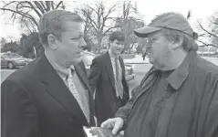  ?? IFC FILMS ?? Rep. John Tanner, D-tenn., left, and filmmaker Michael Moore talk outside the U.S. Capitol in Washington, in a scene from Moore’s 2004 documentar­y. “Fahrenheit 911.”