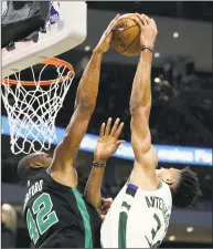  ?? Dylan Buell / Getty Images ?? Al Horford, left, of the Celtics blocks a shot attempt by Giannis Antetokoun­mpo of the Bucks in the third quarter of Sunday’s game in Milwaukee.