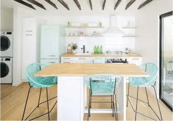  ??  ?? The kitchen and dining area in a Node bungalow. Developers see co-living — already common in European cities — as the next step in the sharing economy, ideal for millennial­s used to Uber and Airbnb.