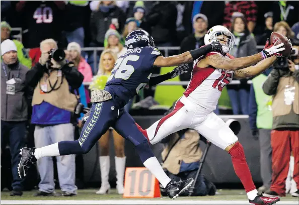  ?? — THE ASSOCIATED PRESS ?? Arizona Cardinals wide receiver Michael Floyd catches a pass for a touchdown as Seattle Seahawks cornerback Cary Williams defends during the first half of an NFL football game on Sunday in Seattle. Arizona won the game 39-32.