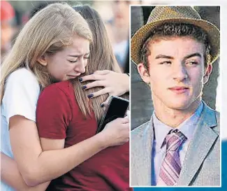  ?? Pictures: AFP ?? Pupils in tears yesterday before a vigil at the school. Inset, British pupil Lewis Mizen