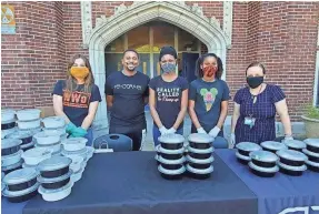  ?? JAE HENDERSON ?? On Tuesday, chef Phillip Dewayne (second from the left) of Park + Cherry Cafe provided free meals for families of Humes Middle School.