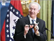  ?? (Arkansas DemocratGa­zette/ Thomas Metthe) ?? Gov. Asa Hutchinson shows the McGehee Owls mask that was sent to him during the start of the daily COVID-19 briefing Wednesday at the state Capitol in Little Rock.