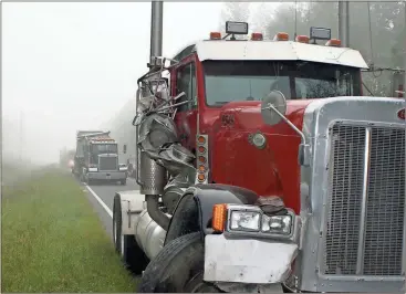  ?? Doug Walker / Rome News-Tribune ?? The side of a soybean hauler shows the damage from a wreck with a log truck. The log truck hit two of the soybean trucks spilling beans all over Alabama Highway. None of the drivers suffered serious injuries.