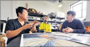  ??  ?? ■ Graff.io Steve Barradell, 43, MD (right), Andy Harper, 39, Head of creative technology (centre) with fine art photograph­er Peter Li, 38, discussing a project.